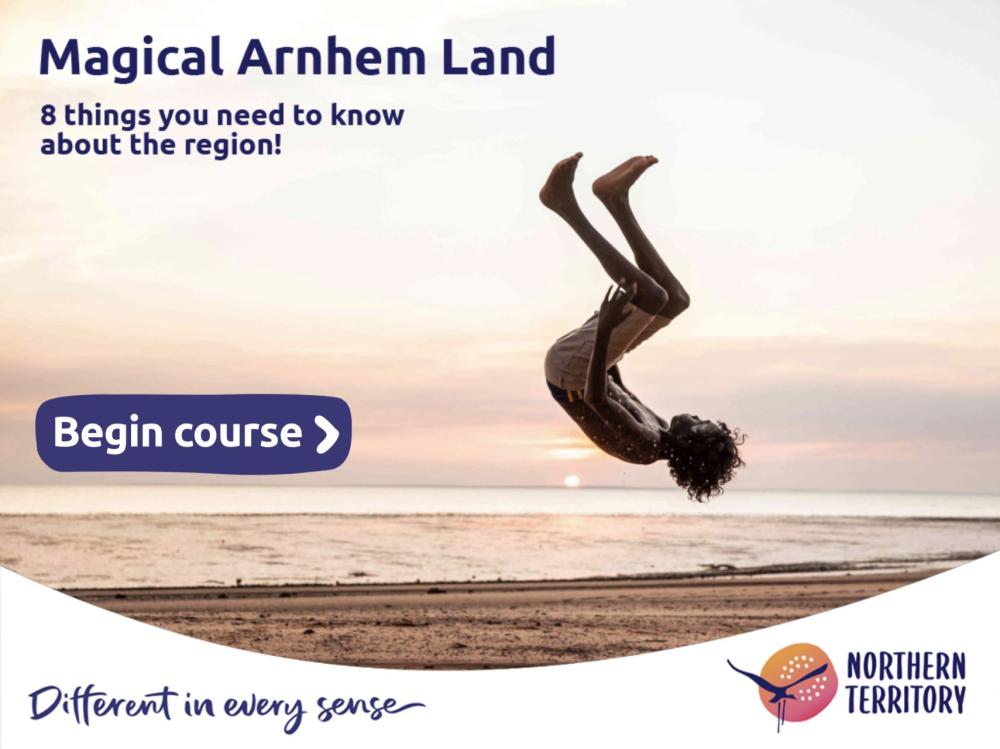 Boy doing a backflip on the beach at sunset
